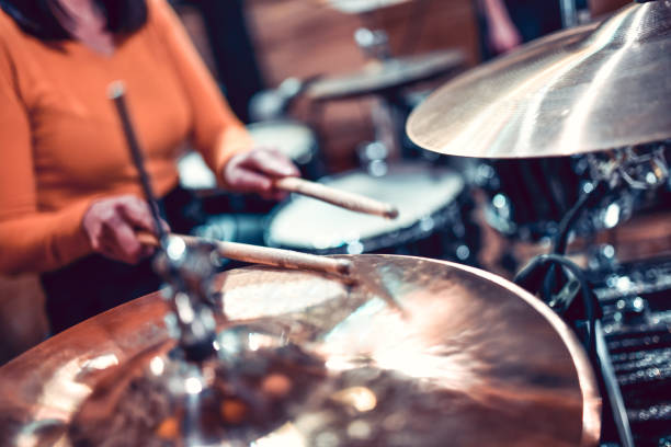 istock Female Drummer Hitting The Cymbals 1299288388