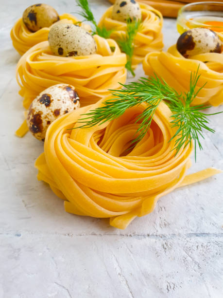 raw pasta,  egg on a concrete background