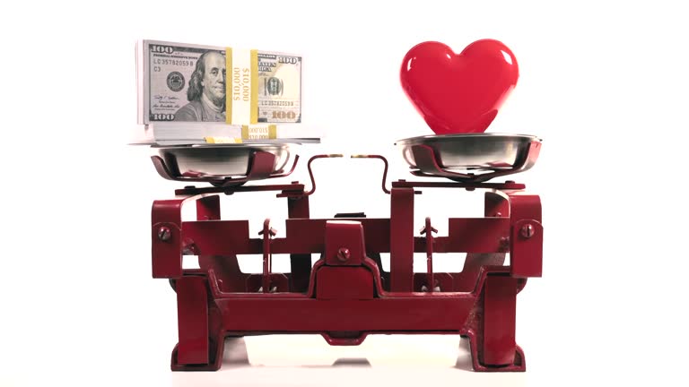 Heart and money on a weight scale