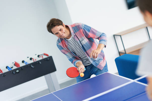 istock Group of students playing table tennis in the campus 1299294464