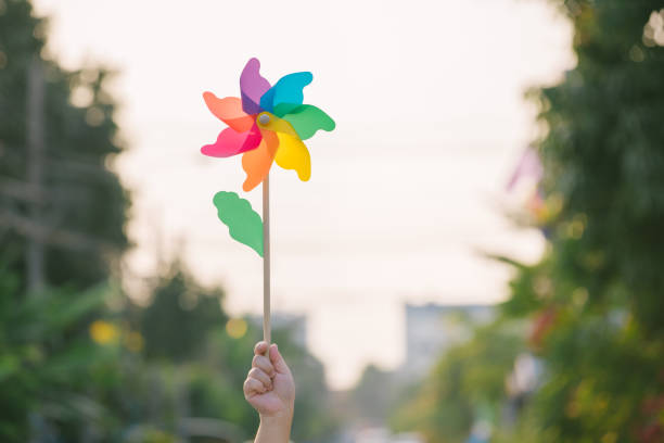 Small plastic colorful turbine with orange sky background.