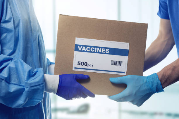 istock medical worker accepting box delivery of vaccines from courier 1299299107