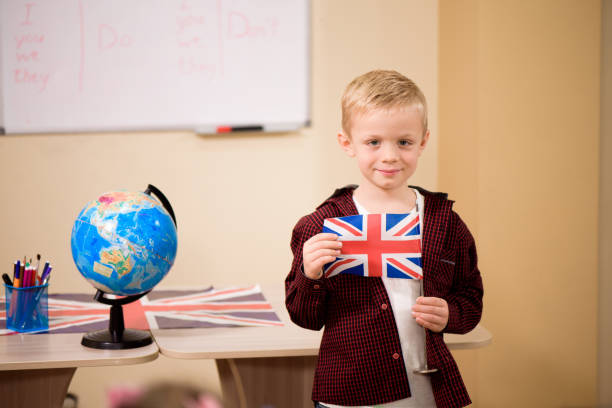 istock Portrait of a boy looking at camera in the classroom. 1299299256