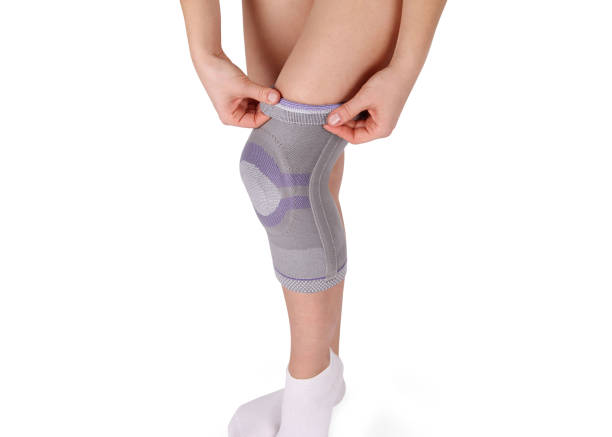 istock Knee Support Brace on leg isolated on white background. Orthopedic Anatomic Orthosis. Braces for knee fixation, injuries and pain. Orthotics. Foot orthosis. Knee Joint Bandage Sleeve. Elastic Sports 1299299527
