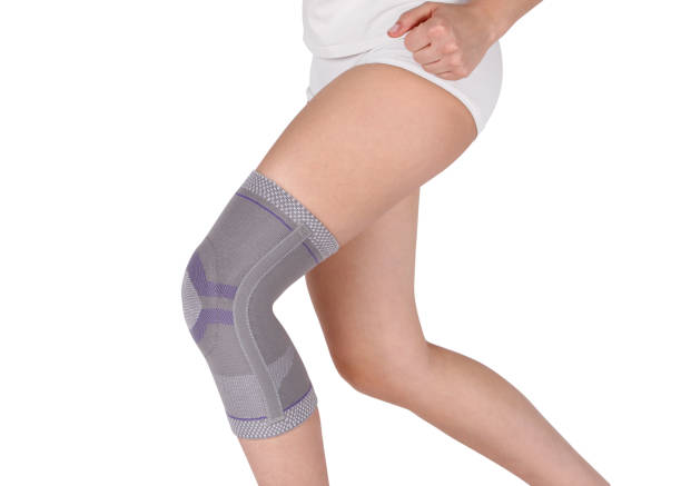 istock Knee Support Brace on leg isolated on white background. Orthopedic Anatomic Orthosis. Braces for knee fixation, injuries and pain. Orthotics. Foot orthosis. Knee Joint Bandage Sleeve. Elastic Sports 1299299528