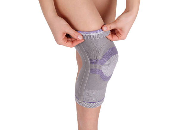 istock Knee Support Brace on leg isolated on white background. Orthopedic Anatomic Orthosis. Braces for knee fixation, injuries and pain. Orthotics. Foot orthosis. Knee Joint Bandage Sleeve. Elastic Sports 1299299530