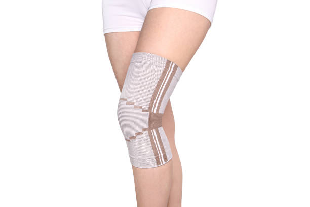 istock Knee Support Brace on leg isolated on white background. Orthopedic Anatomic Orthosis. Braces for knee fixation, injuries and pain. Orthotics. Foot orthosis. Knee Joint Bandage Sleeve. Elastic Sports 1299299532
