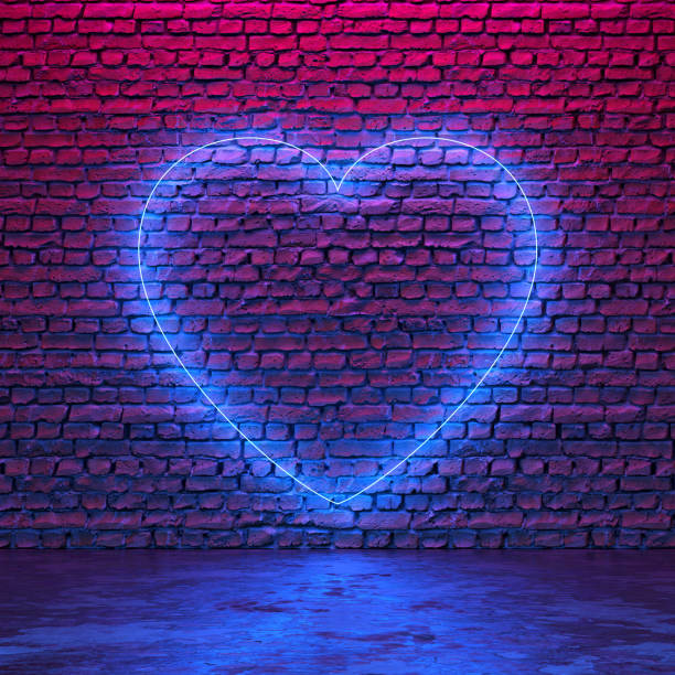 istock Glowing neon heart shaped like icon on brick wall in dark room 1299300425