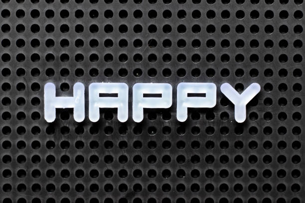 istock White color alphabet with word happy on black pegboard background 1299302219