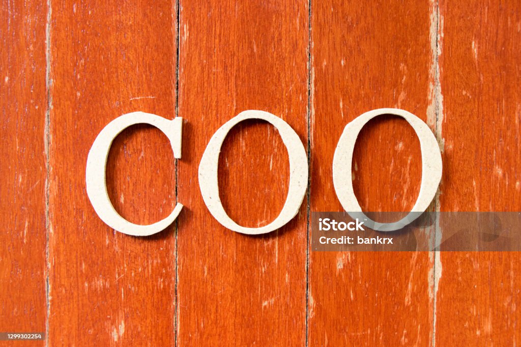 Alphabet letter in word COO (abbreviation Chief operating officer) on old red color wood plate background COO Stock Photo