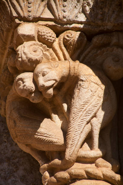 Ancient column that embellish the entrance to San Esteban de Ribas de Miño church, decorated with beautiful carvings in stone. Ribeira Sacra touristic area, Lugo province, Galicia, Spain.