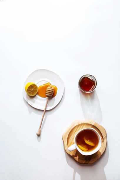 istock Herbal tea with honey and lemon on a light background, healthy food concept. Minimalistic flat lay with copy space. 1299303329