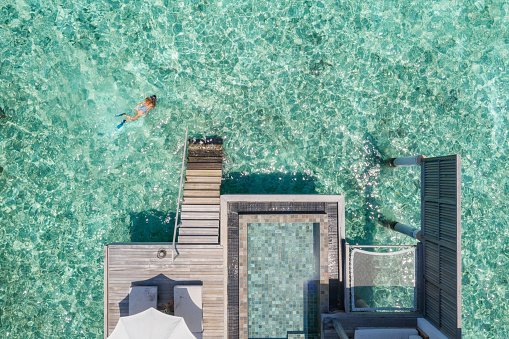 View from directly above, she swims in the reef of the Island\nLuxury hotel