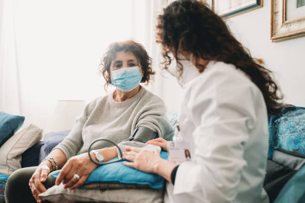 istock Doctor is visiting a patient at home, checking the patient's blood pressure 1299306701