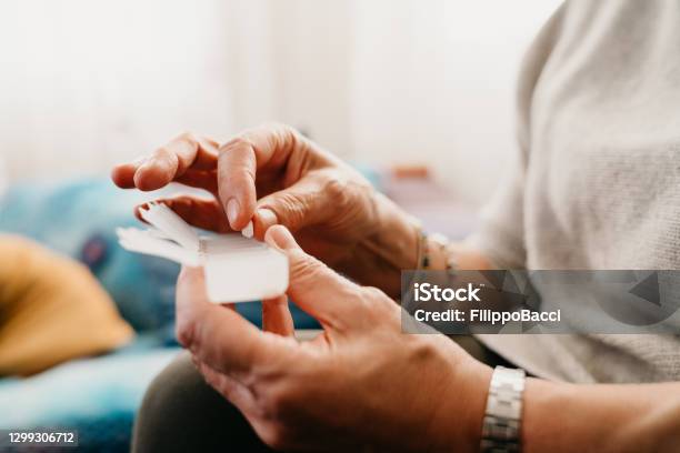 Close Up Shot A Mature Woman Taking And Organizing Medicines Stock Photo - Download Image Now