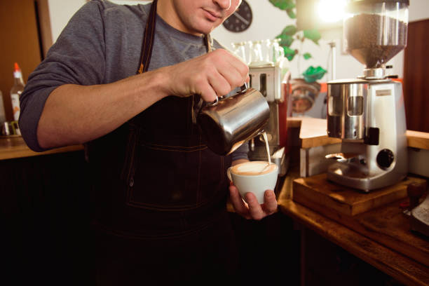istock Coffee Latte Barista making pattern in a cup of coffee shop. 1299307646