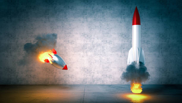 istock two rockets start but one fails to launch. 1299308020