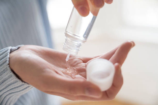 istock Young Caucasian woman squeezing hand sanitizer into her palm 1299308189
