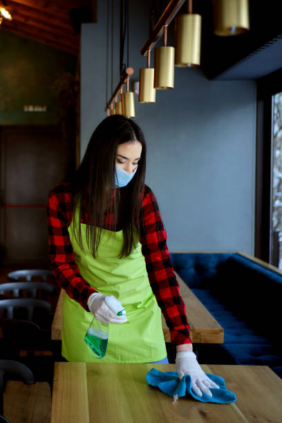 istock Waitress working at a restaurant wearing a facemask during the COVID-19 pandemic 1299308871