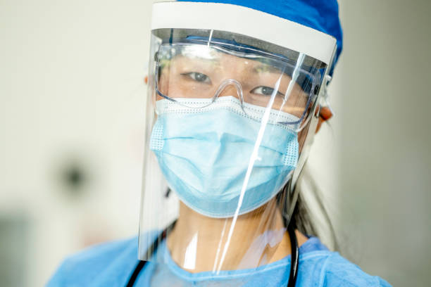 istock Female doctor dressed in personal protective equipment 1299309032