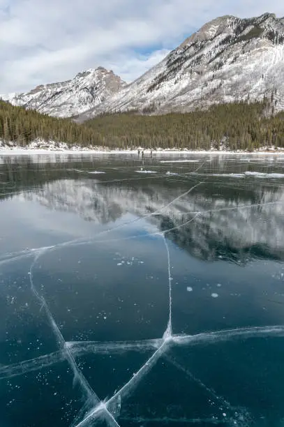 Cracked ice on frozen Lake Minnewanka in Banff National Park, Alberta, Canada
