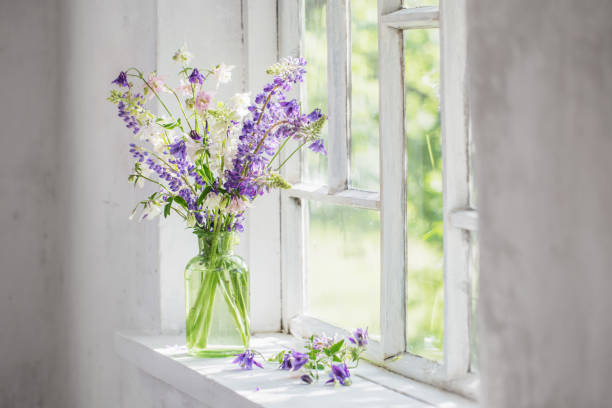 istock summer flowers in vase on windowsill in sunlight 1299309400