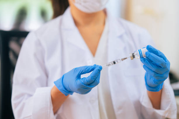 istock Close-up image of doctor`s hands preparing syringe in doctor`s office 1299309977