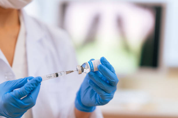 istock Close-up image of doctor`s hands preparing syringe in doctor`s office 1299310001