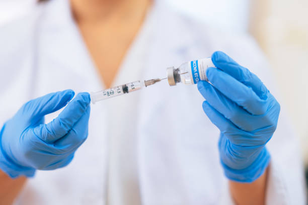 istock Close-up image of doctor`s hands preparing syringe in doctor`s office 1299310058