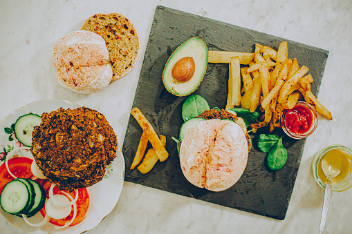 Vegan vegetable burger with avocado and chips