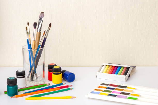 istock On a white worktop table with drawing supplies and brushes 1299311634