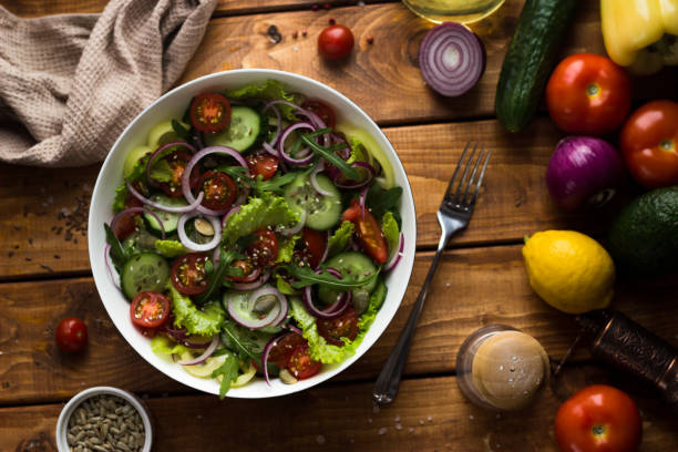 istock vegetable vegetrian salad in a white plate on a wooden table in the kitchen 1299313042