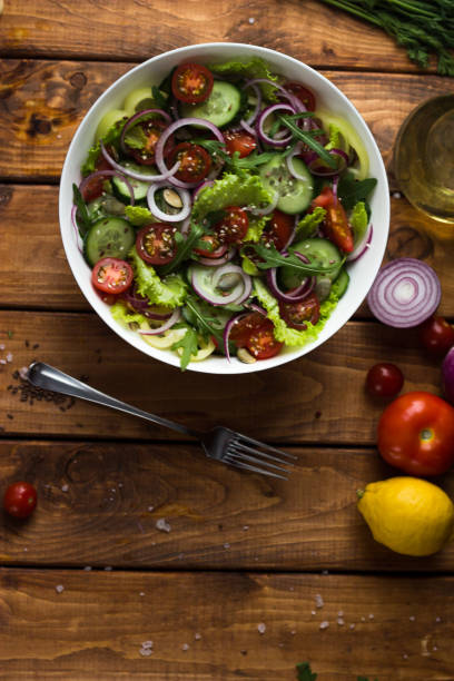 istock vegetable vegetrian salad in a white plate on a wooden table in the kitchen 1299313104
