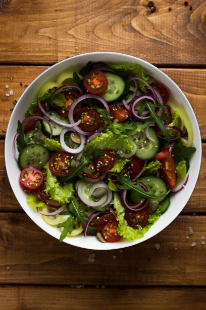 istock vegetable vegetrian salad in a white plate on a wooden table in the kitchen 1299313121