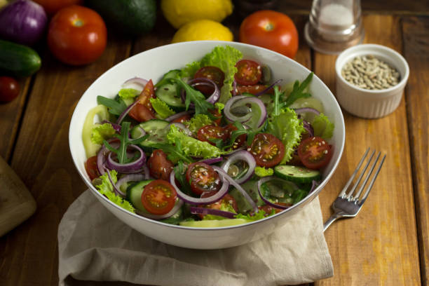 istock vegetable vegetrian salad in a white plate on a wooden table in the kitchen 1299313250