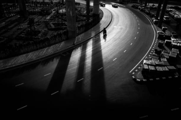 istock road and shadow with traffic in black and white color. 1299316181