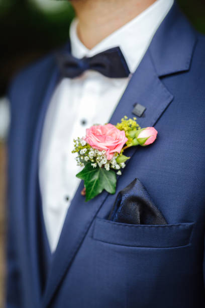 istock Groom wearing a boutonniere at his wedding 1299317452