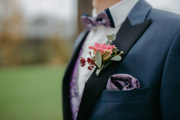 istock Groom wearing a boutonniere at his wedding 1299317638