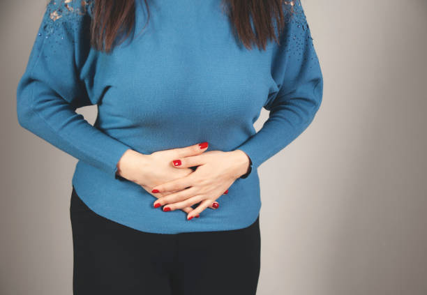 istock woman hand in ache stomache 1299317691