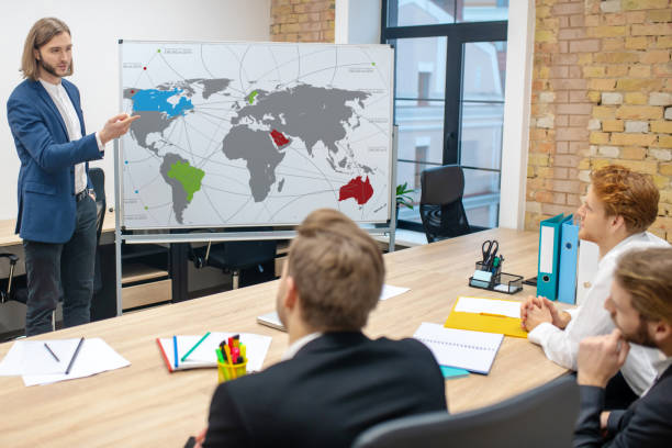 istock Man standing near stand and sitting colleagues 1299319765