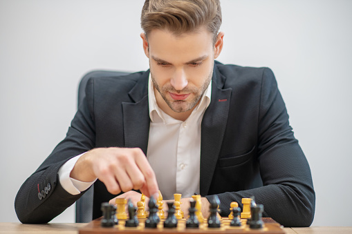 Young Man Placing Chess Pieces On Chessboard Stock Photo - Download ...