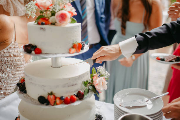 istock Bride and groom cutting the wedding cake 1299320018