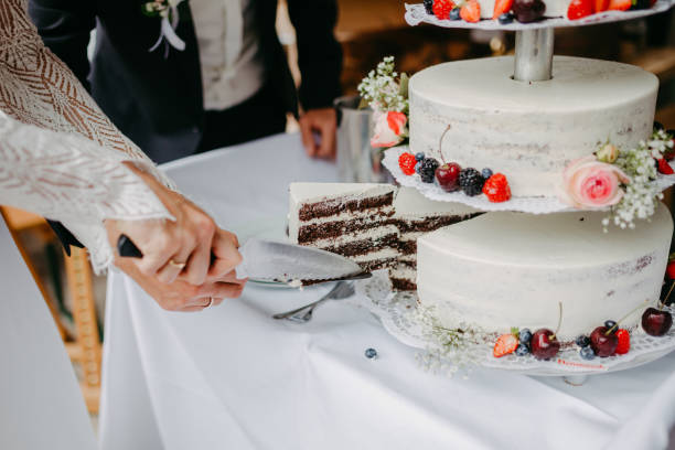 istock Bride and groom cutting the wedding cake 1299320067