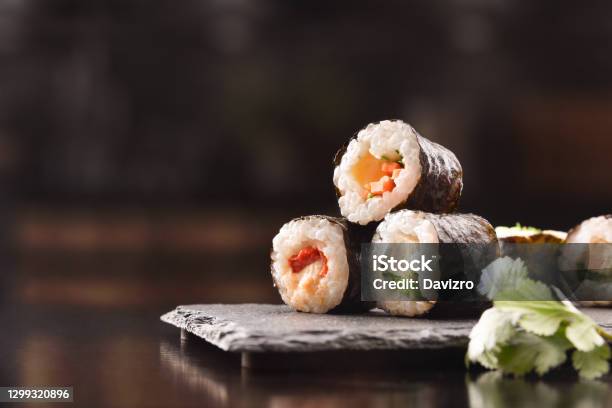 Sushi Maki On Slate Plate And Chopsticks Close Up Front Stock Photo - Download Image Now