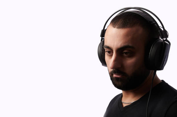istock Young arabian man dj with headphones on isolated background 1299320966