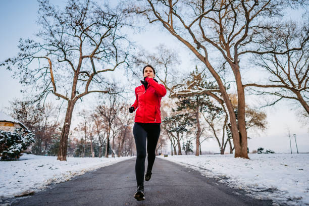 istock Woman running on winter day in park 1299322124