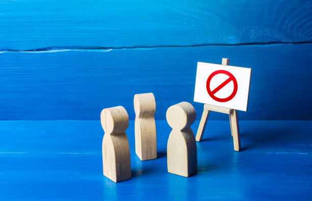istock A group of people figurines looking at an easel with a red prohibitory symbol NO. Expression of protest and disagreement. Inaccessibility and absence. Quarantine and lockdown. Hard restrictions 1299322295