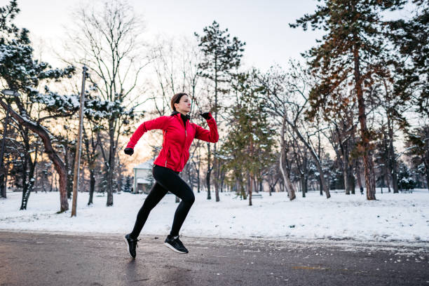 istock Woman running on winter day in park 1299322419