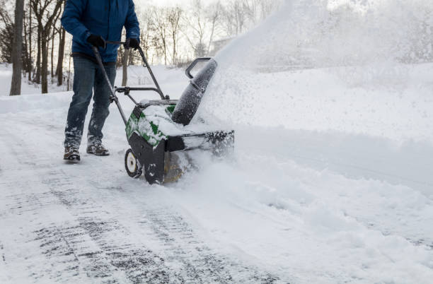 istock Snow blower in action clearing a residential driveway after snow storm 1299322496