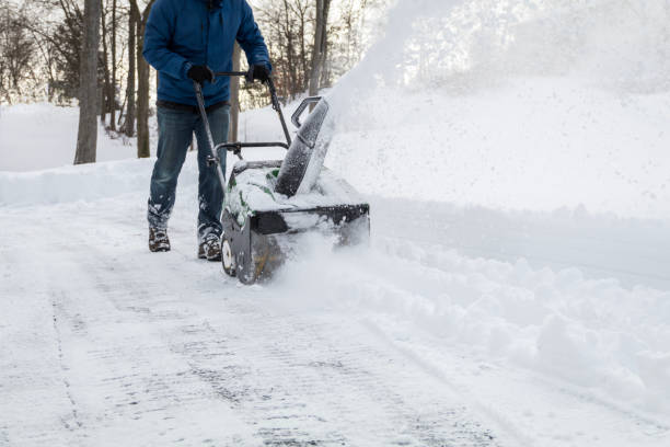 istock Snow blower in action clearing a residential driveway after snow storm 1299322499